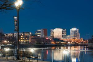 WILMINGTON, DE - APRIL 5, 2018: Wilmington, Delaware Riverwalk and Skyline  along the Christiana River at night